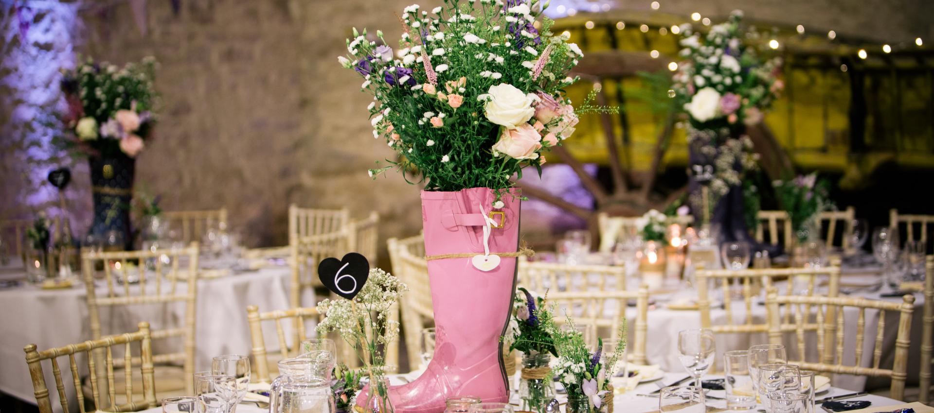 wedding table with pink wellie as flower vase