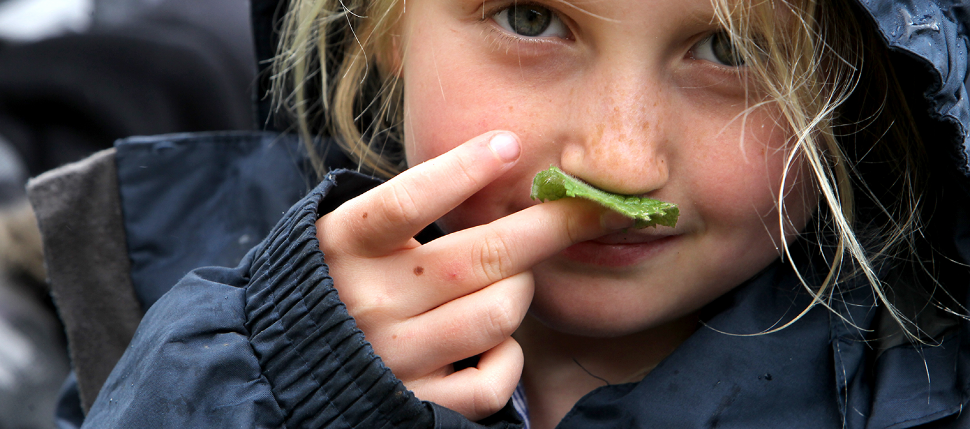 Senses - girl smells a leaf for outdoor education