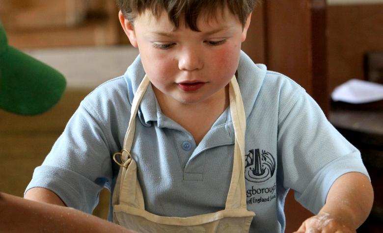 boy baking in apron 